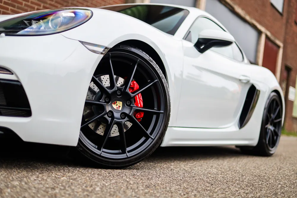 Zwarte velg met rode remklauw van de Porsche 718 Cayman